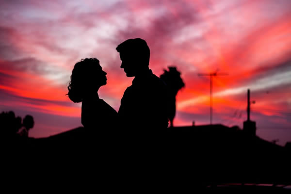 Couple embracing in a pink sunset